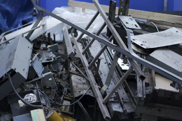 aluminum scrap imports tariff exemption Section 232: a pile of metal scrap next to a blue wall